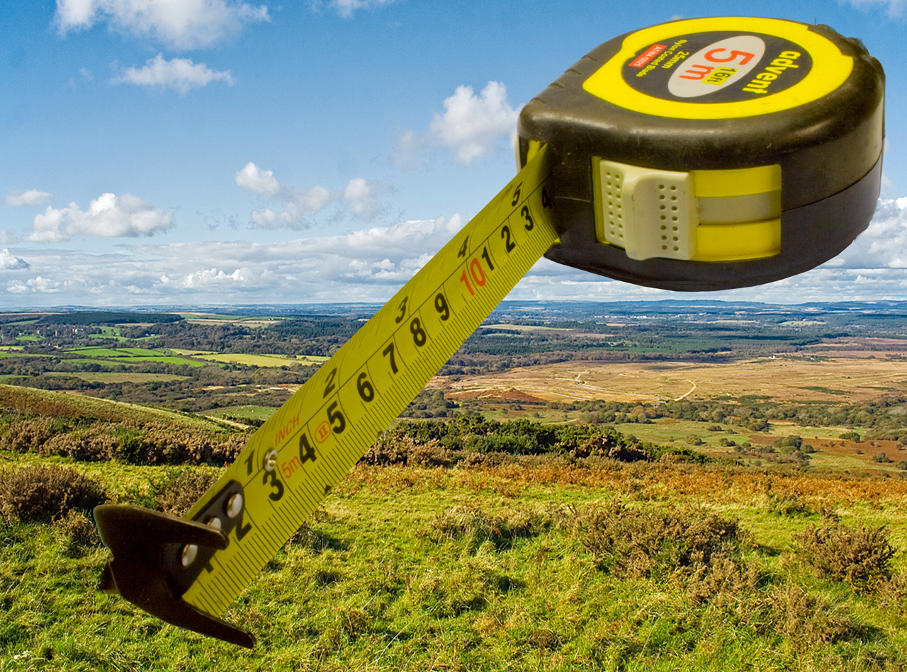 A measuring tape superimposed on the English countryside
