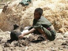 Woman making coffee in fields near Lalibela