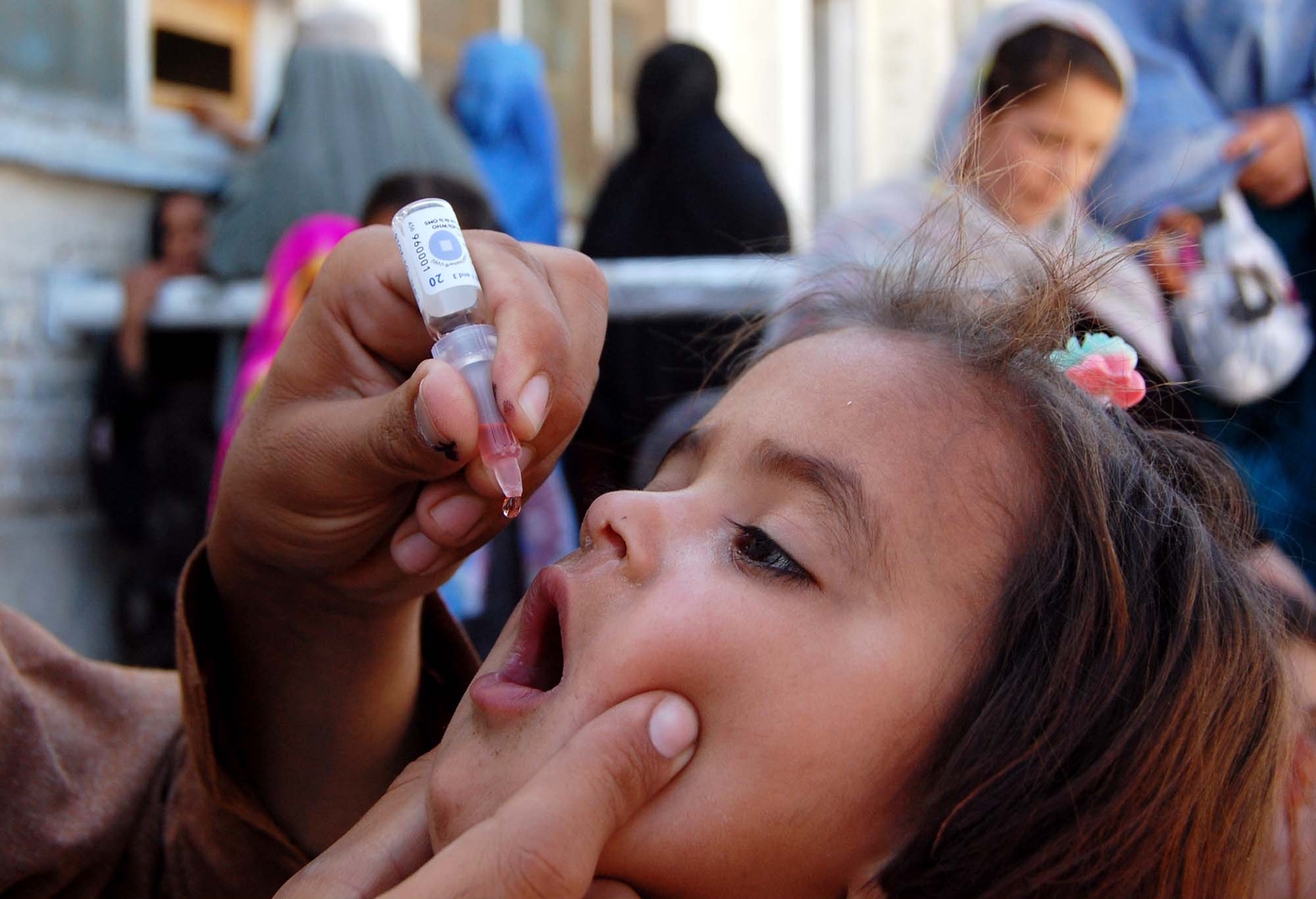 Health worker administrates polio-vaccine drops to a child during anti-polio immunization campaign at Pak-Afghan Border on April 08, 2015