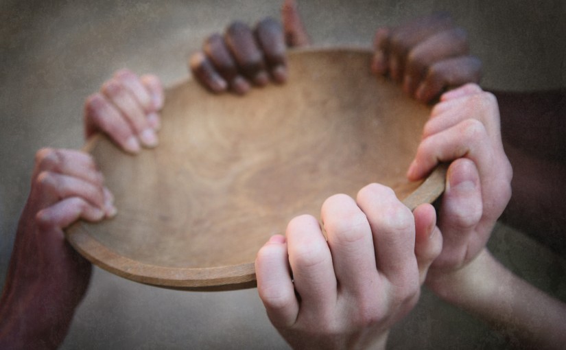 hands holding a wooden plate